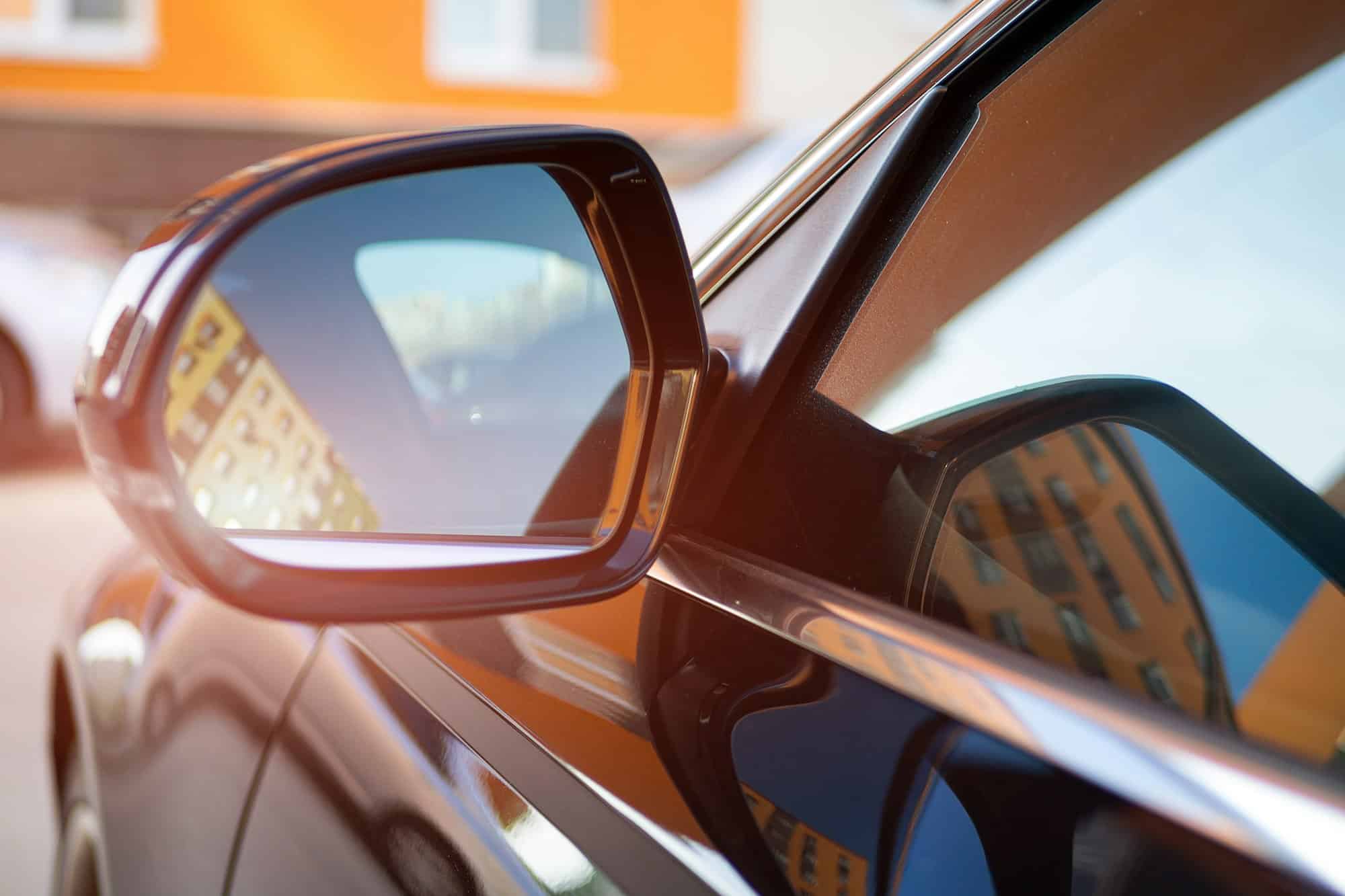 Anti-glare rearview mirror on a black car.