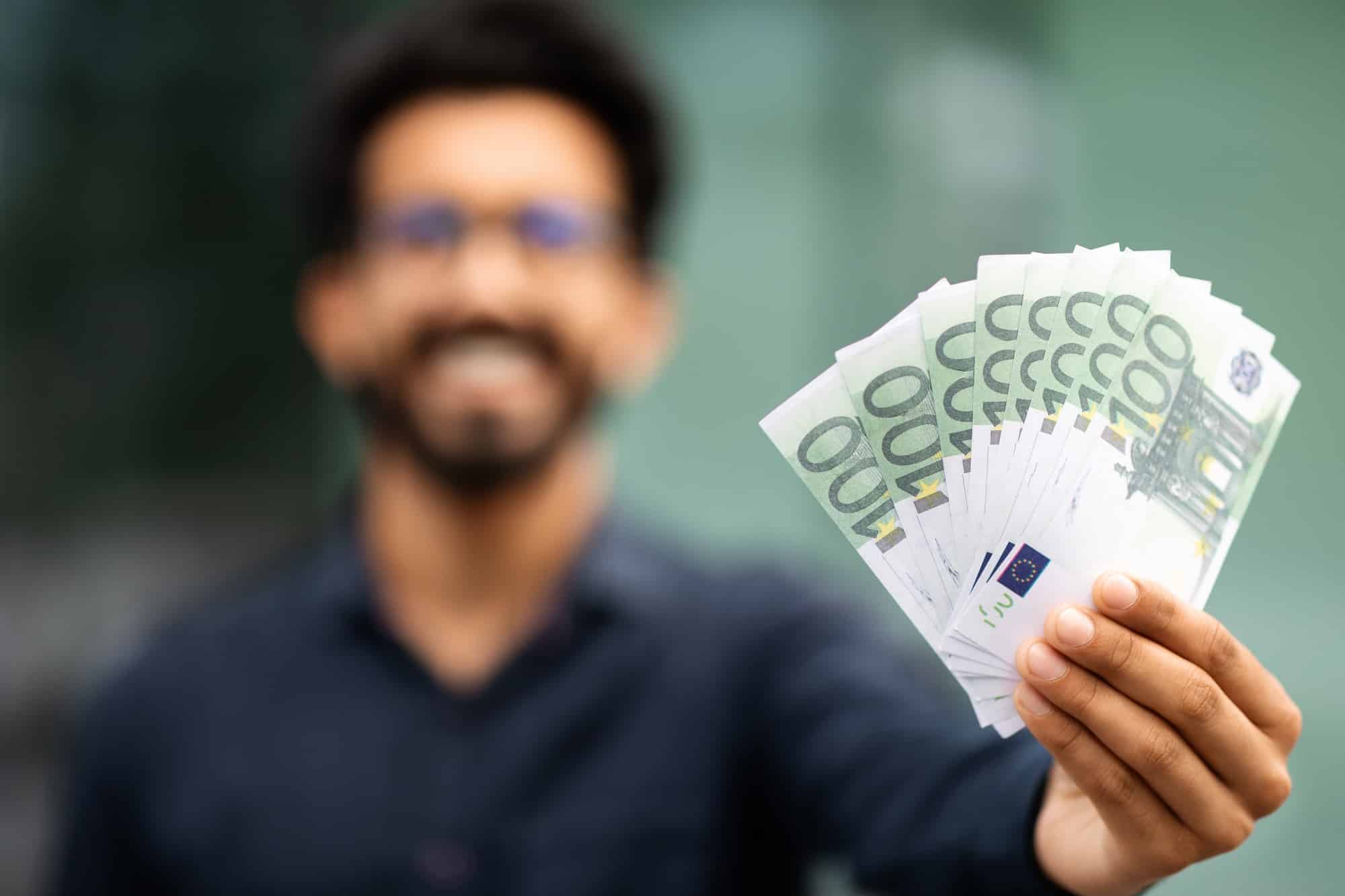 Cash money euro banknotes in middle eastern businessman hand