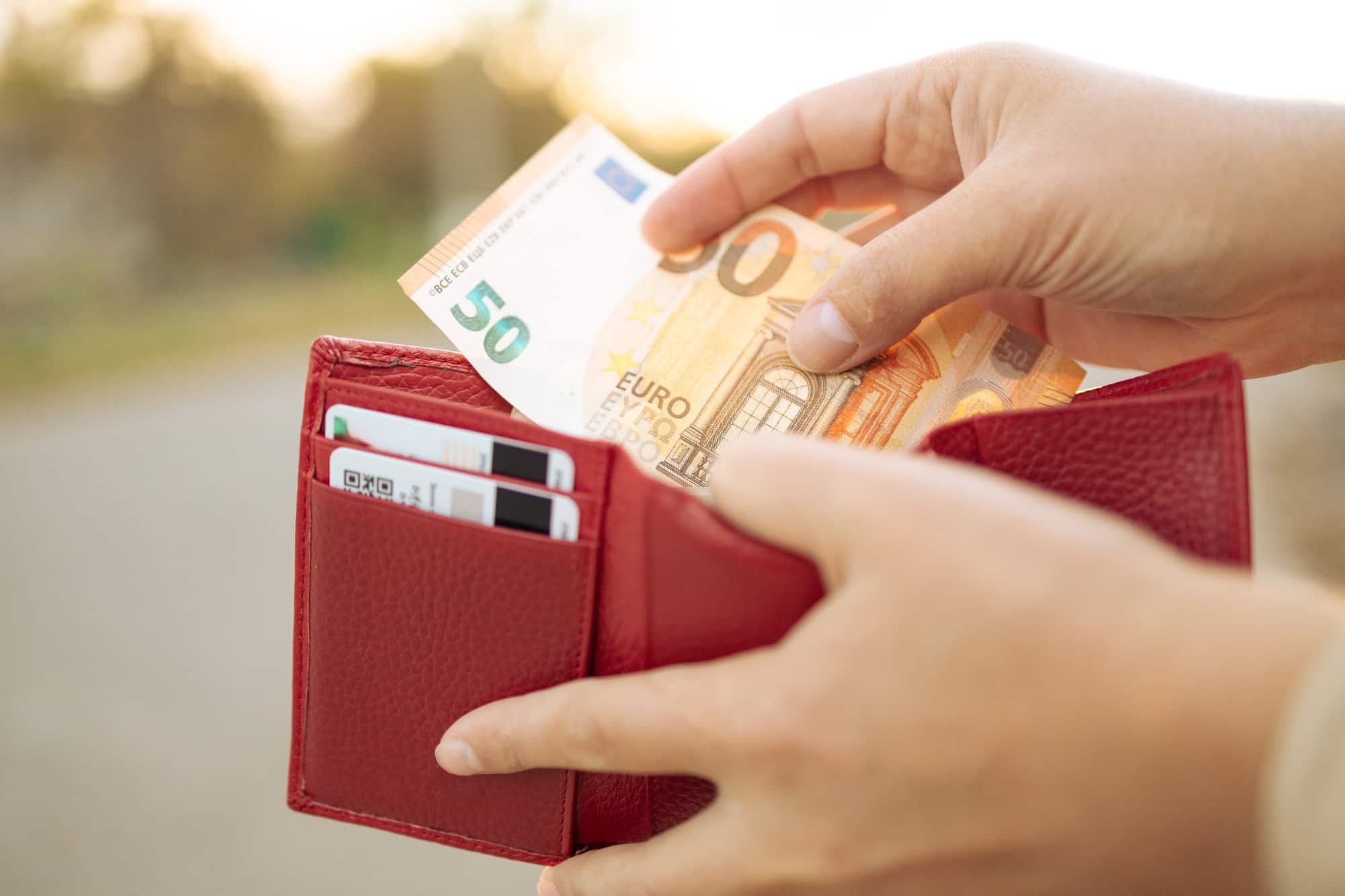 Woman holding in hands wallet with euro money